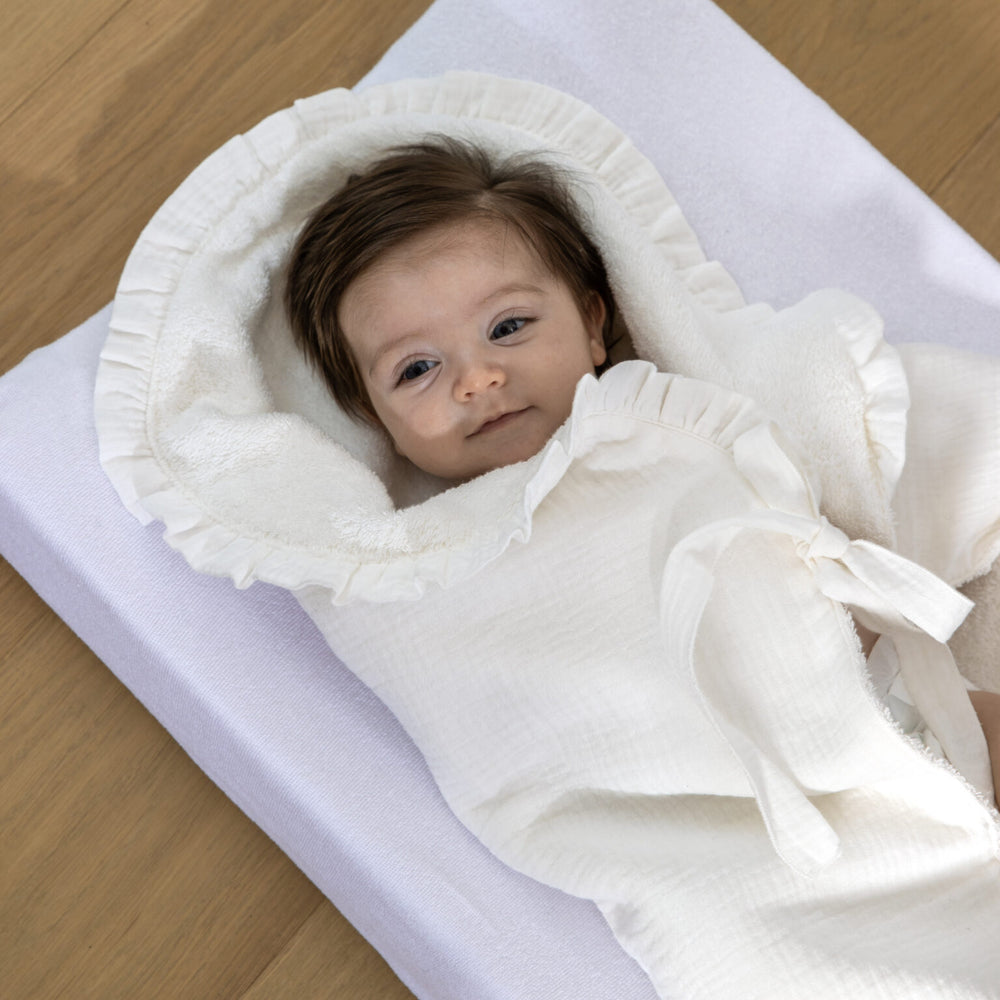 Baby in zachte ecru badcape handdoek van tetra en badstof 