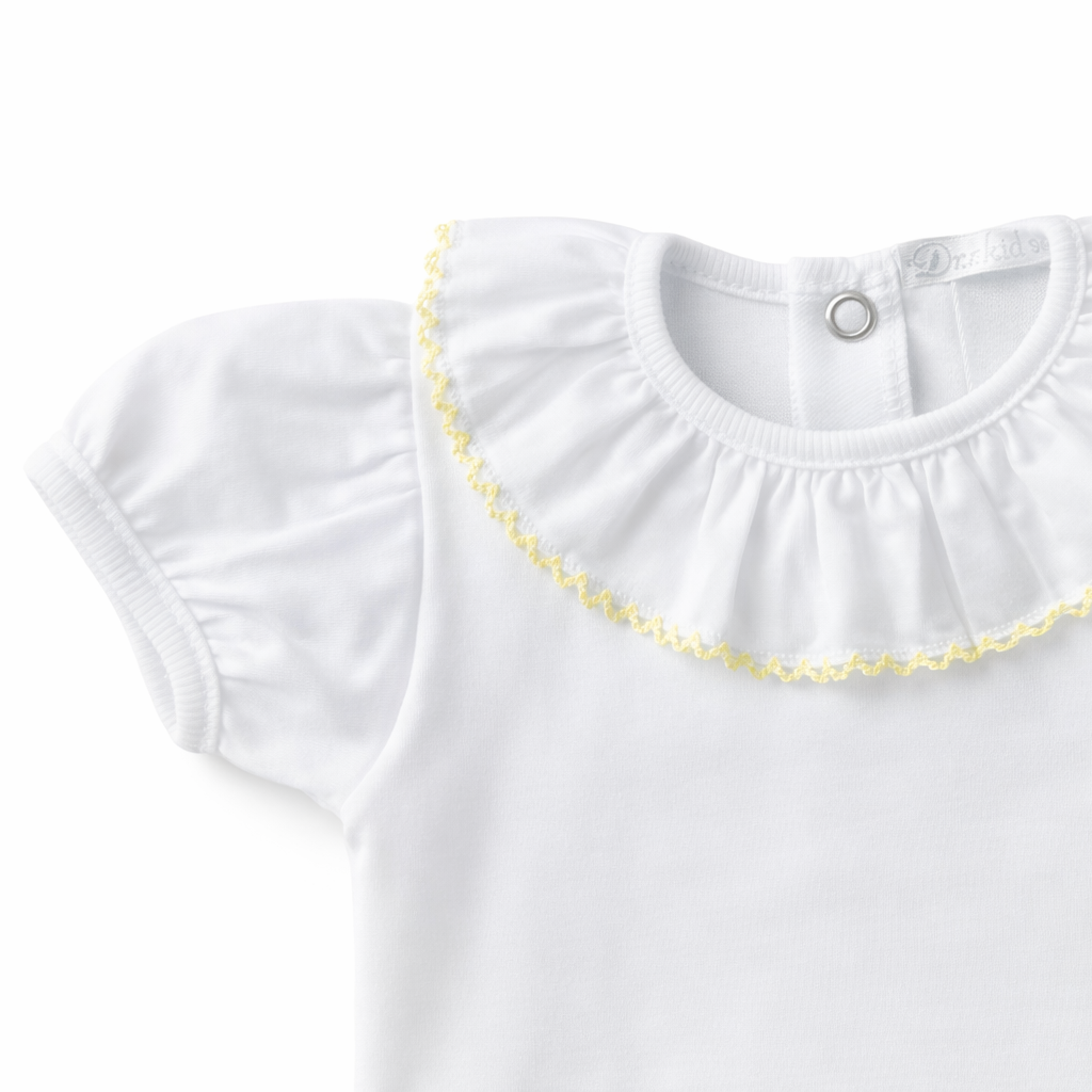 Detail van witte romper met pofmouwtjes en gele bies van het merk Dr. Kid