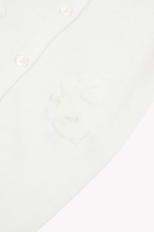 Detail van crèmekleurig boxpakje van Tartine et Chocolat met zachte konijnenapplicatie